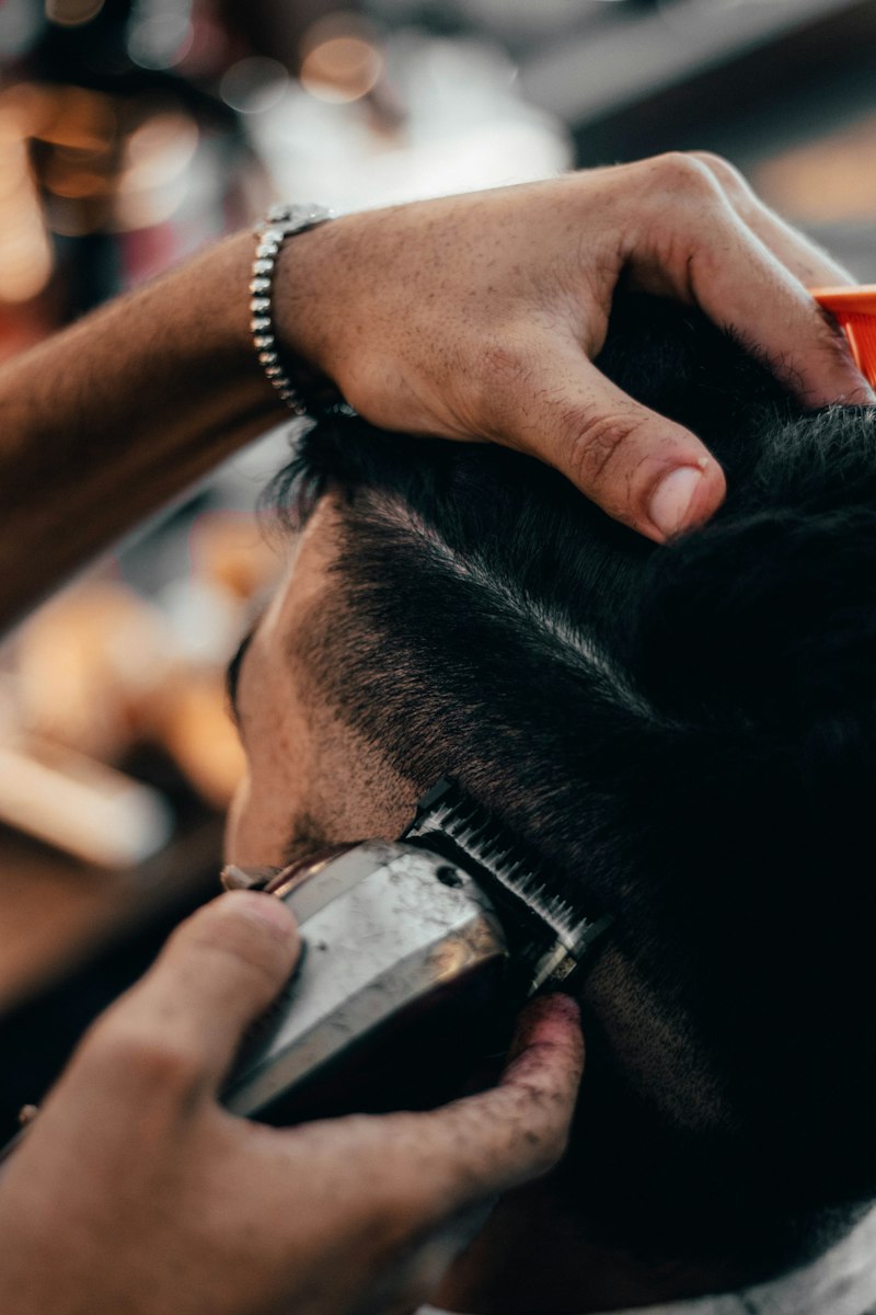 Barber shaping a skin fade